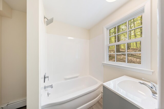 24 Newtown Tpke, Redding, CT 06896 - bathroom featuring wood finished floors, tub / shower combination, vanity, and baseboard heating