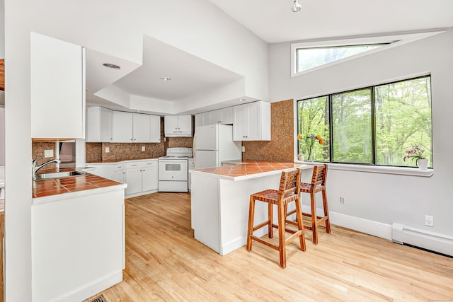 32 Old Bethel Rd, Newtown, CT 06470 - kitchen with white appliances, tile countertops, a sink, and a peninsula