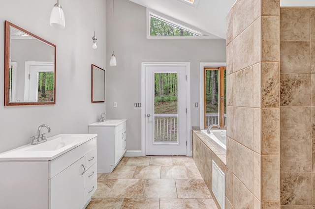32 Old Bethel Rd, Newtown, CT 06470 - bathroom with two vanities, a bath, and high vaulted ceiling
