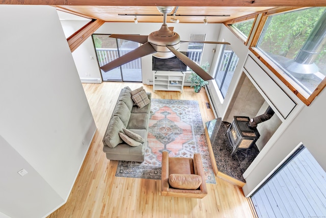 32 Old Bethel Rd, Newtown, CT 06470 - living room with wood finished floors, rail lighting, a wood stove, and baseboards