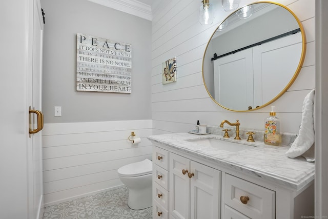 bathroom featuring wooden walls, ornamental molding, vanity, toilet, and tile patterned flooring