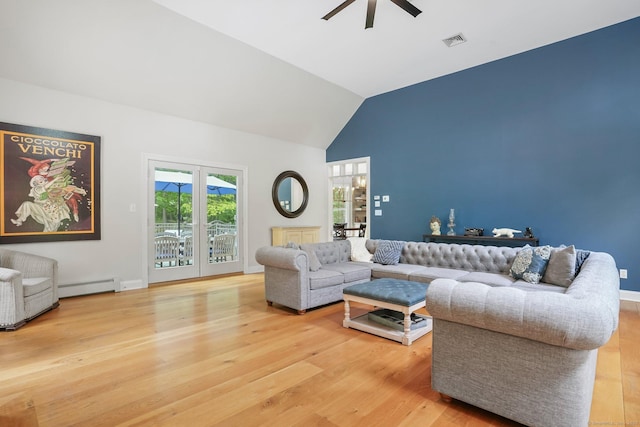 living room featuring baseboard heating, ceiling fan, light wood-style floors, and high vaulted ceiling