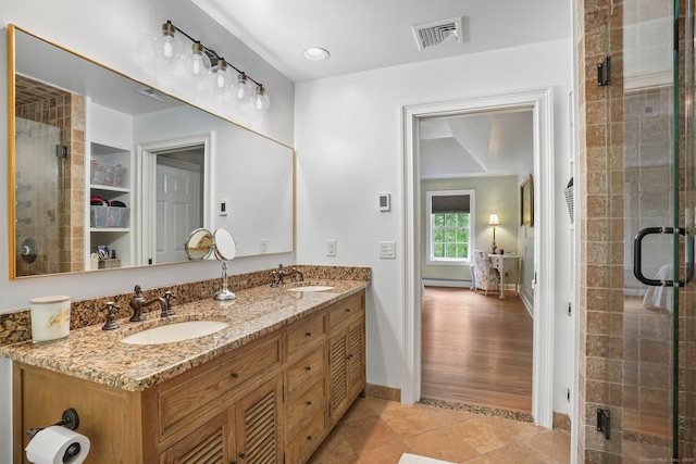 full bath with baseboards, a stall shower, tile patterned floors, and double vanity