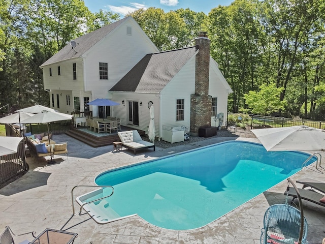 view of swimming pool featuring a deck, an outdoor living space, a patio, and outdoor dining space