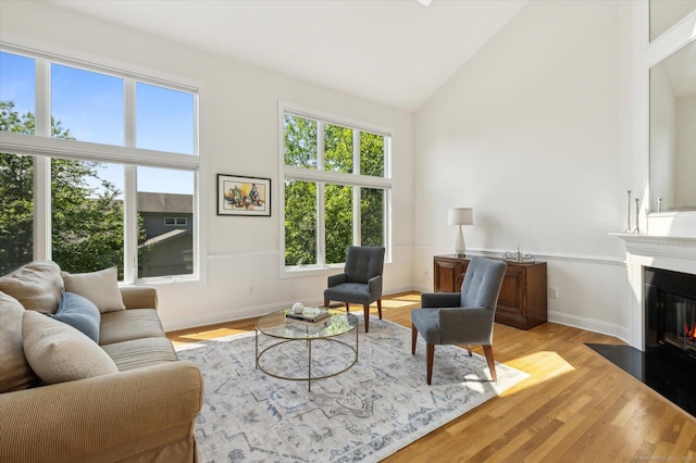 7 Wyndemere Unit 7, Avon, CT 06001 - living area with high vaulted ceiling, light wood-style flooring, a fireplace with flush hearth, and baseboards