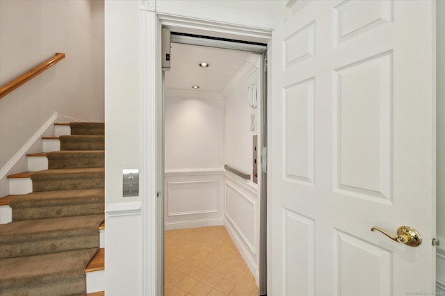 7 Wyndemere Unit 7, Avon, CT 06001 - stairs with a decorative wall, elevator, a wainscoted wall, and tile patterned flooring