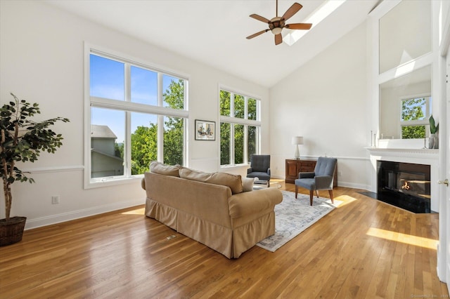 7 Wyndemere Unit 7, Avon, CT 06001 - living area featuring a ceiling fan, high vaulted ceiling, wood finished floors, a fireplace with flush hearth, and baseboards