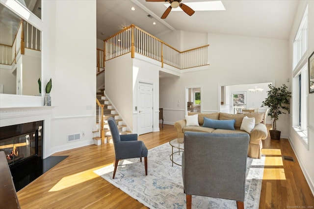 7 Wyndemere Unit 7, Avon, CT 06001 - living area with stairs, ceiling fan, wood finished floors, baseboards, and high vaulted ceiling
