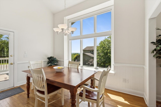 7 Wyndemere Unit 7, Avon, CT 06001 - dining area featuring plenty of natural light, a chandelier, light wood-style floors, a wainscoted wall, and lofted ceiling