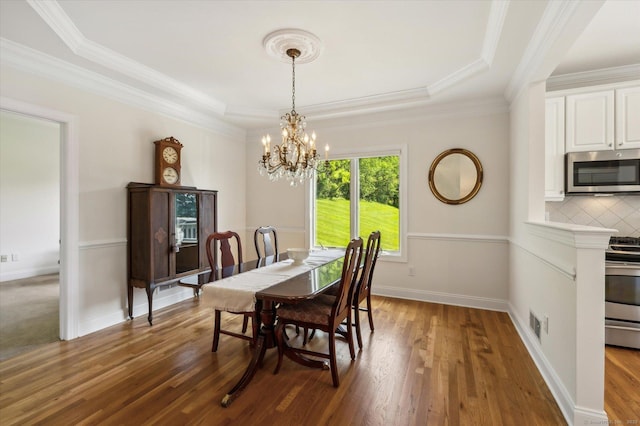 7 Wyndemere Unit 7, Avon, CT 06001 - dining room featuring a chandelier, wood finished floors, a tray ceiling, crown molding, and baseboards