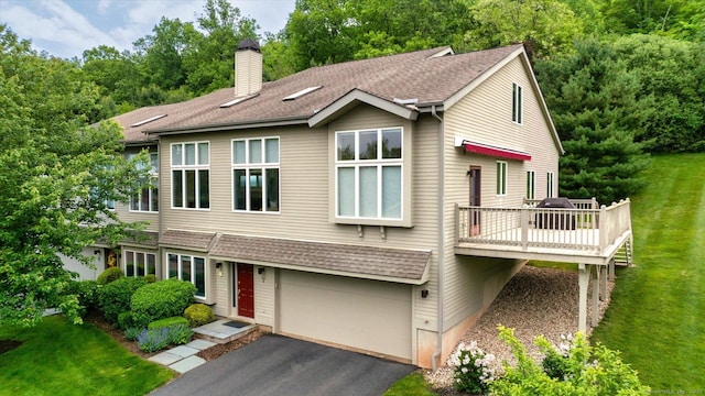7 Wyndemere Unit 7, Avon, CT 06001 - view of front of house with a garage, a front yard, a chimney, a deck, and asphalt driveway