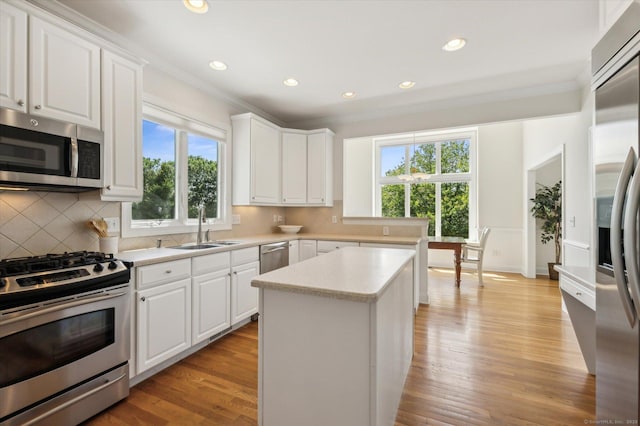 7 Wyndemere Unit 7, Avon, CT 06001 - kitchen with appliances with stainless steel finishes, ornamental molding, a sink, plenty of natural light, and light countertops