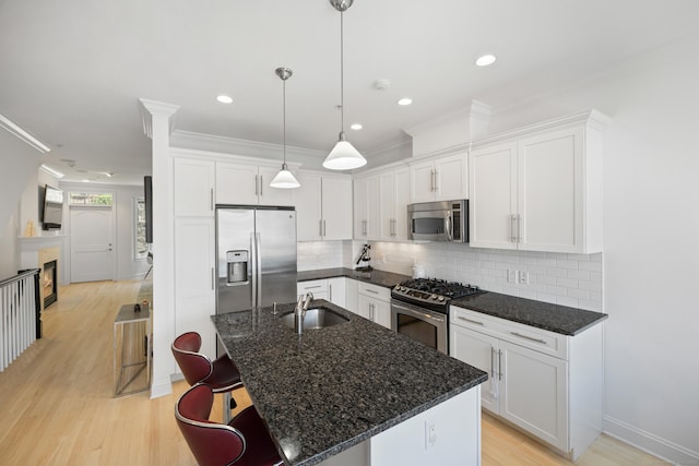 442 Main Ave Unit 18 B6, Norwalk, CT 06851 - kitchen with stainless steel appliances, a sink, ornamental molding, white cabinets, and recessed lighting