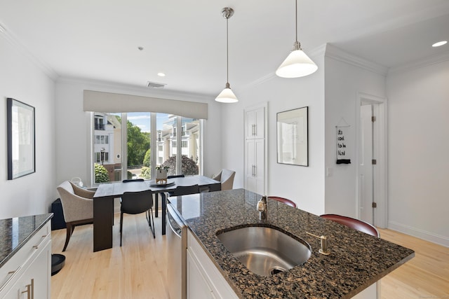 442 Main Ave Unit 18 B6, Norwalk, CT 06851 - kitchen featuring a sink, light wood-style flooring, stainless steel dishwasher, crown molding, and hanging light fixtures