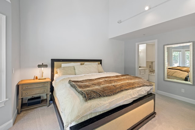 442 Main Ave Unit 18 B6, Norwalk, CT 06851 - bedroom with light carpet, baseboards, connected bathroom, and a high ceiling