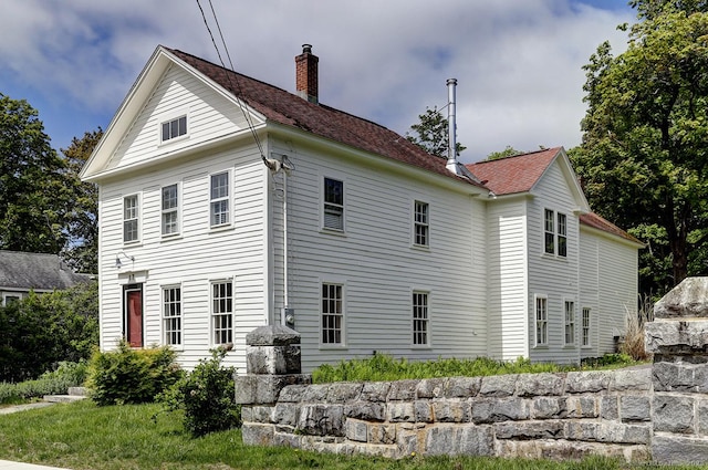 view of property exterior featuring a chimney