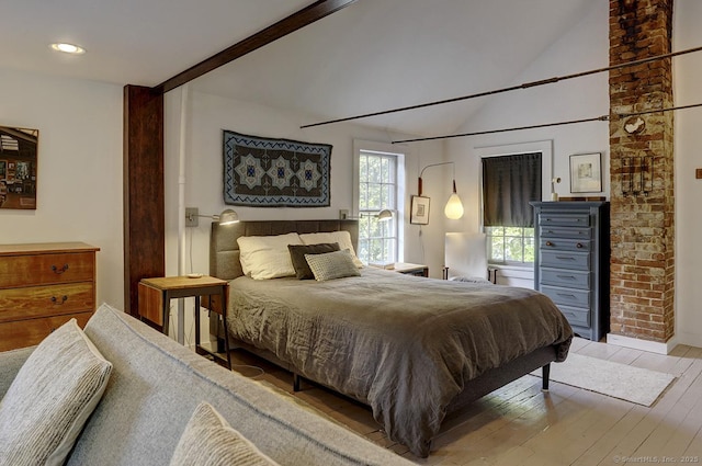 bedroom featuring lofted ceiling and hardwood / wood-style floors