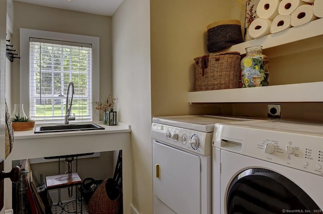 laundry area with washing machine and dryer and plenty of natural light