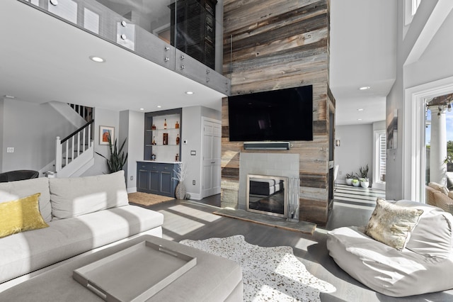 233 Front St Unit 3, New Haven, CT 06513 - living room with a towering ceiling, a fireplace, stairway, wooden walls, and baseboards