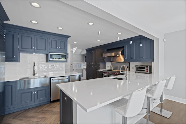 233 Front St Unit 3, New Haven, CT 06513 - kitchen with appliances with stainless steel finishes, a sink, wall chimney exhaust hood, tasteful backsplash, and recessed lighting
