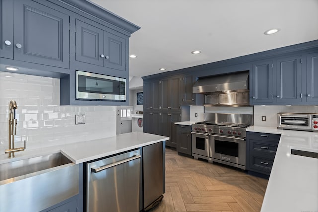 233 Front St Unit 3, New Haven, CT 06513 - kitchen with wall chimney exhaust hood, appliances with stainless steel finishes, a sink, light countertops, and recessed lighting