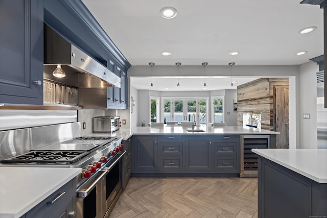 233 Front St Unit 3, New Haven, CT 06513 - kitchen featuring beverage cooler, double oven range, a peninsula, a sink, and light countertops