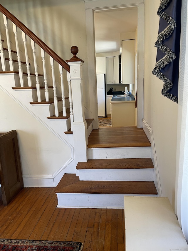 674 Williams St, New London, CT 06320 - stairway featuring wood-type flooring and baseboards