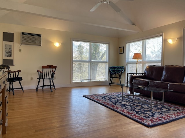 674 Williams St, New London, CT 06320 - living room featuring a wall unit AC, wood finished floors, vaulted ceiling, baseboards, and ceiling fan