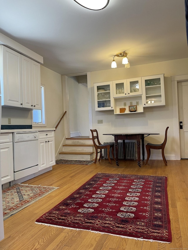 674 Williams St, New London, CT 06320 - dining room featuring stairway, radiator heating unit, light wood-style flooring, and baseboards