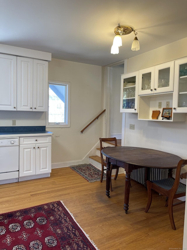 674 Williams St, New London, CT 06320 - dining room with stairway, light wood-type flooring, radiator heating unit, and baseboards