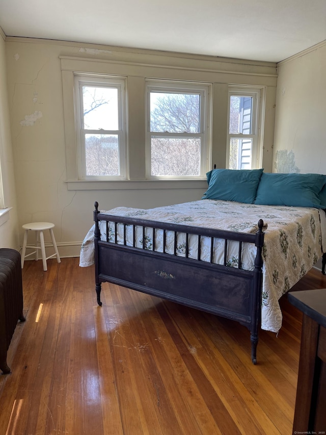 674 Williams St, New London, CT 06320 - bedroom with radiator, wood-type flooring, baseboards, and ornamental molding