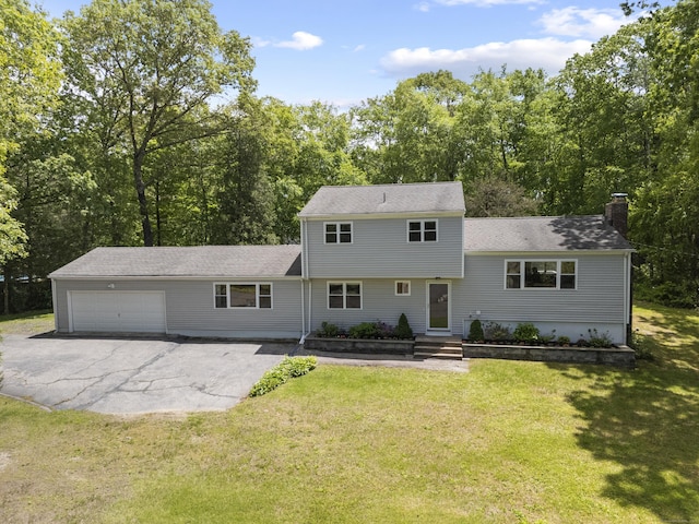 15 Ridgewood Dr, Monroe, CT 06468 - tri-level home with an attached garage, a chimney, driveway, and a front yard