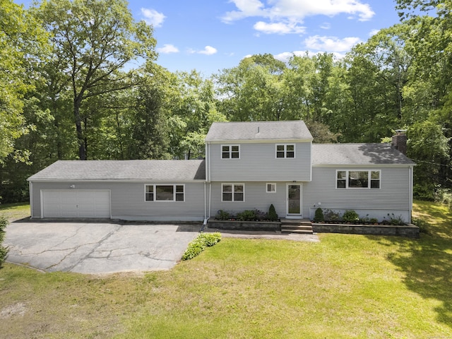 15 Ridgewood Dr, Monroe, CT 06468 - view of front of home with an attached garage, a chimney, asphalt driveway, and a front yard