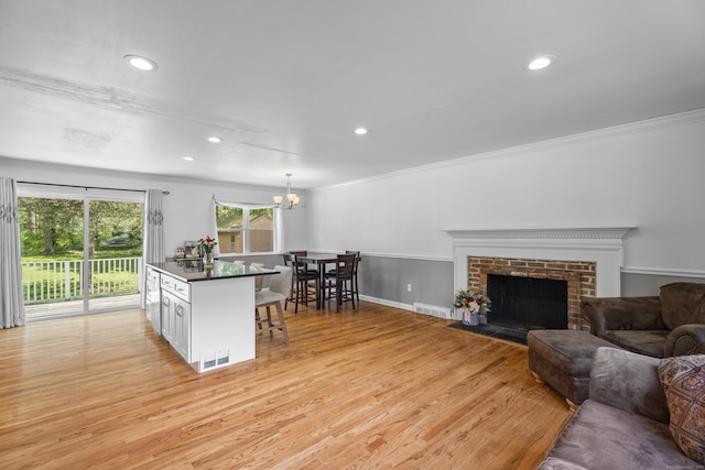 15 Ridgewood Dr, Monroe, CT 06468 - kitchen with dark countertops, ornamental molding, a breakfast bar, recessed lighting, and a chandelier