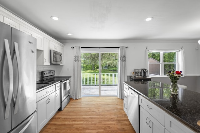 15 Ridgewood Dr, Monroe, CT 06468 - kitchen with stainless steel appliances, white cabinetry, ornamental molding, dark stone counters, and light wood-style flooring