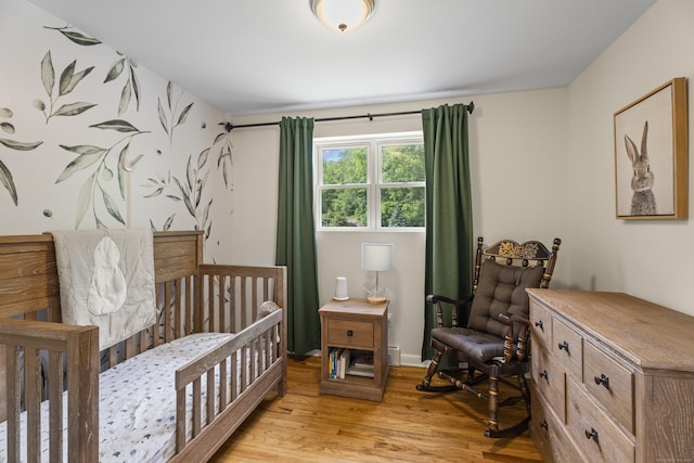 15 Ridgewood Dr, Monroe, CT 06468 - bedroom with light wood-type flooring and a crib