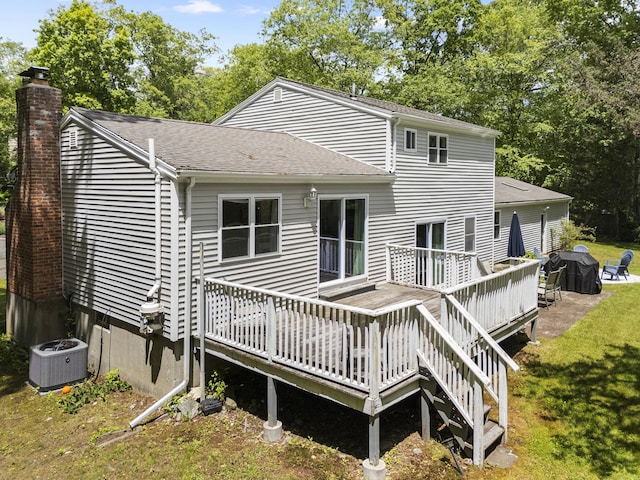 15 Ridgewood Dr, Monroe, CT 06468 - rear view of house with central AC unit, a wooden deck, roof with shingles, a chimney, and a yard