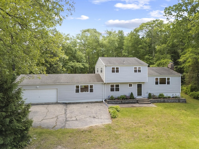 15 Ridgewood Dr, Monroe, CT 06468 - split level home featuring an attached garage, a front lawn, a chimney, and a shingled roof