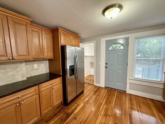 16-1/2 W Main St, Norwalk, CT 06851 - kitchen featuring stainless steel fridge with ice dispenser, baseboards, backsplash, and light wood finished floors