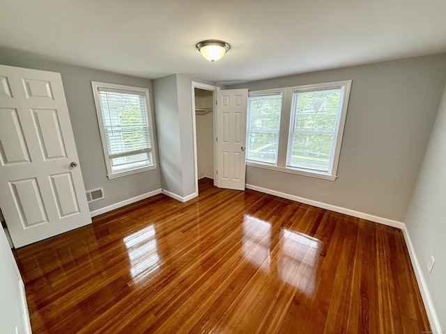 16-1/2 W Main St, Norwalk, CT 06851 - unfurnished bedroom featuring wood finished floors, baseboards, and a closet