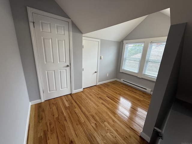 16-1/2 W Main St, Norwalk, CT 06851 - unfurnished bedroom with a baseboard heating unit, wood finished floors, lofted ceiling, and baseboards