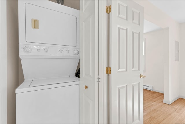 2 Lakeview Cir E, Lyme, CT 06357 - washroom featuring stacked washer / dryer, a baseboard heating unit, electric panel, light wood-style flooring, and baseboards
