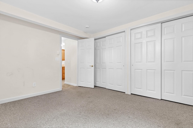 2 Lakeview Cir E, Lyme, CT 06357 - unfurnished bedroom featuring two closets, carpet flooring, and baseboards