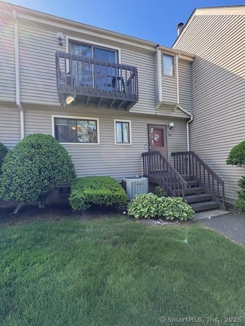 560 Yale Ave Unit 201, Meriden, CT 06450 - view of front of home featuring a balcony, central AC unit, and a front yard