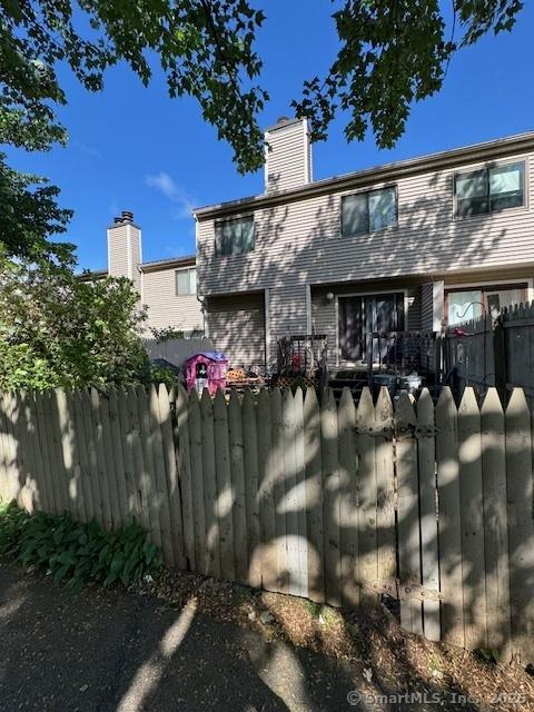 560 Yale Ave Unit 201, Meriden, CT 06450 - back of property with a chimney and an attached garage