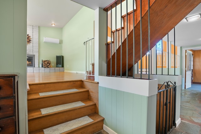 101 Rosengarten Dr, Waterbury, CT 06704 - staircase featuring a large fireplace, a wall unit AC, and stone finish floors