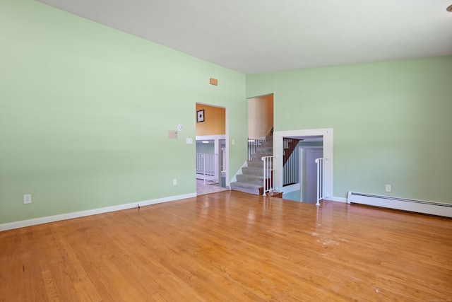 101 Rosengarten Dr, Waterbury, CT 06704 - unfurnished room featuring stairway, a baseboard radiator, wood finished floors, and baseboards