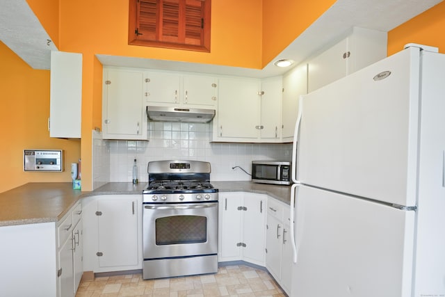 101 Rosengarten Dr, Waterbury, CT 06704 - kitchen featuring appliances with stainless steel finishes, under cabinet range hood, decorative backsplash, and white cabinetry