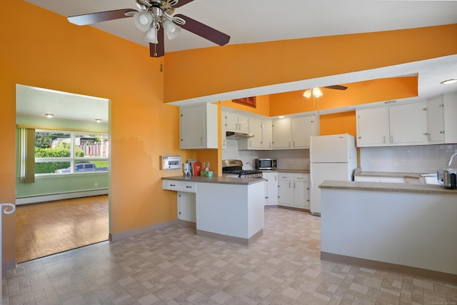 101 Rosengarten Dr, Waterbury, CT 06704 - kitchen featuring freestanding refrigerator, ceiling fan, a baseboard radiator, a peninsula, and gas stove