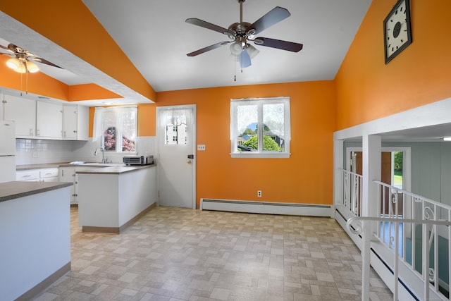 101 Rosengarten Dr, Waterbury, CT 06704 - kitchen with a ceiling fan, freestanding refrigerator, a baseboard radiator, white cabinetry, and high vaulted ceiling